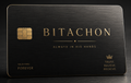 Black metal credit card with a gold crown icon, Hebrew lettering, and the taglines Always in His Hands and Trust. Believe. Receive.
